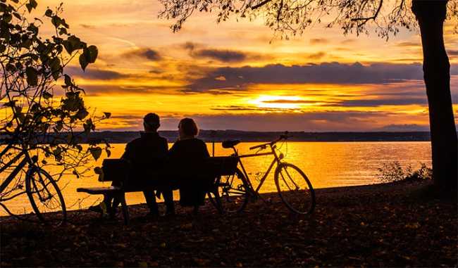 lago tramonto coppia bici
